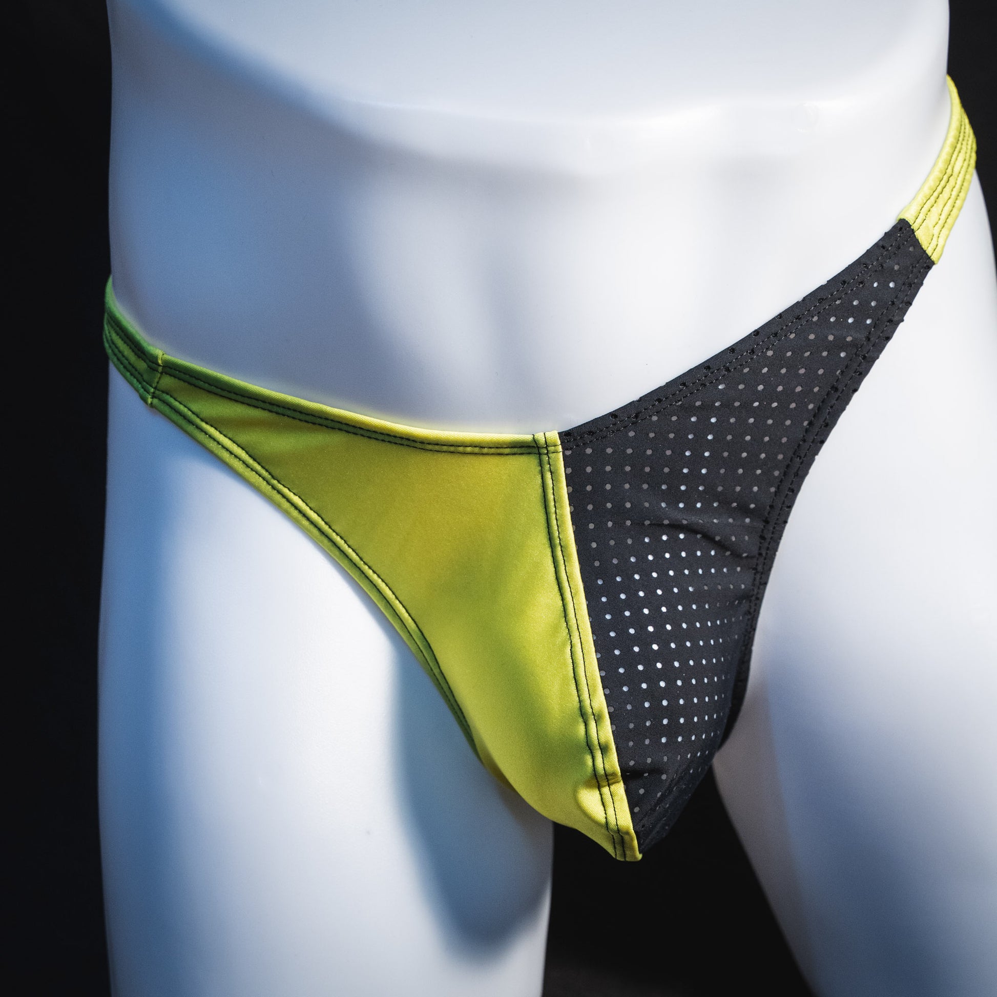 Men's yellow and black mesh thong underwear, classic cut, front view.