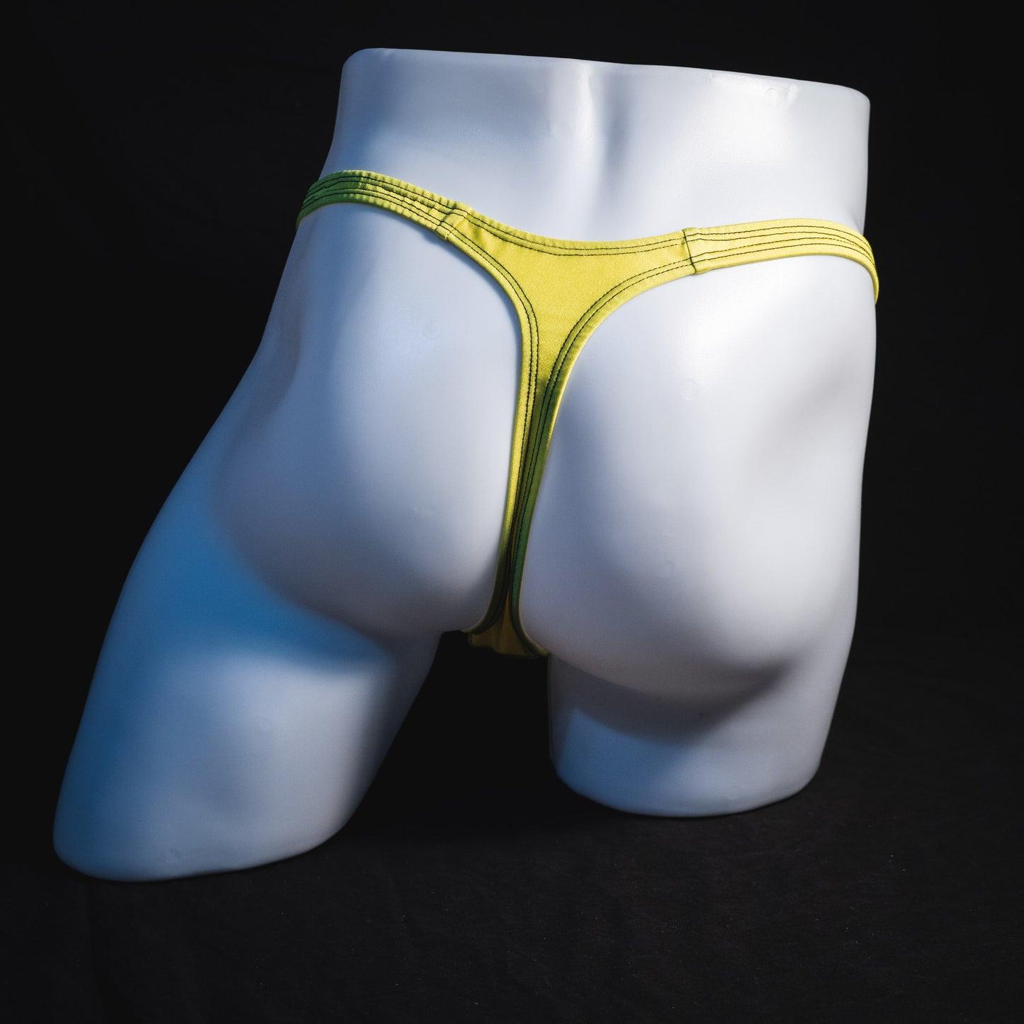 Men's yellow and black mesh thong underwear, classic cut, full rear view.