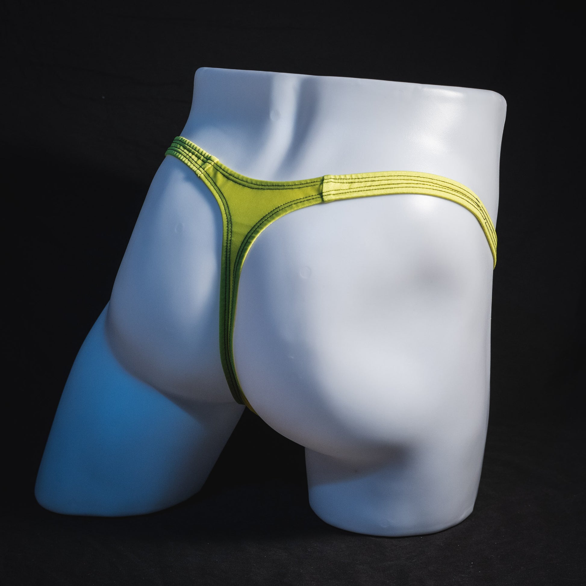 Men's yellow and black mesh thong underwear, classic cut, full angled rear view.