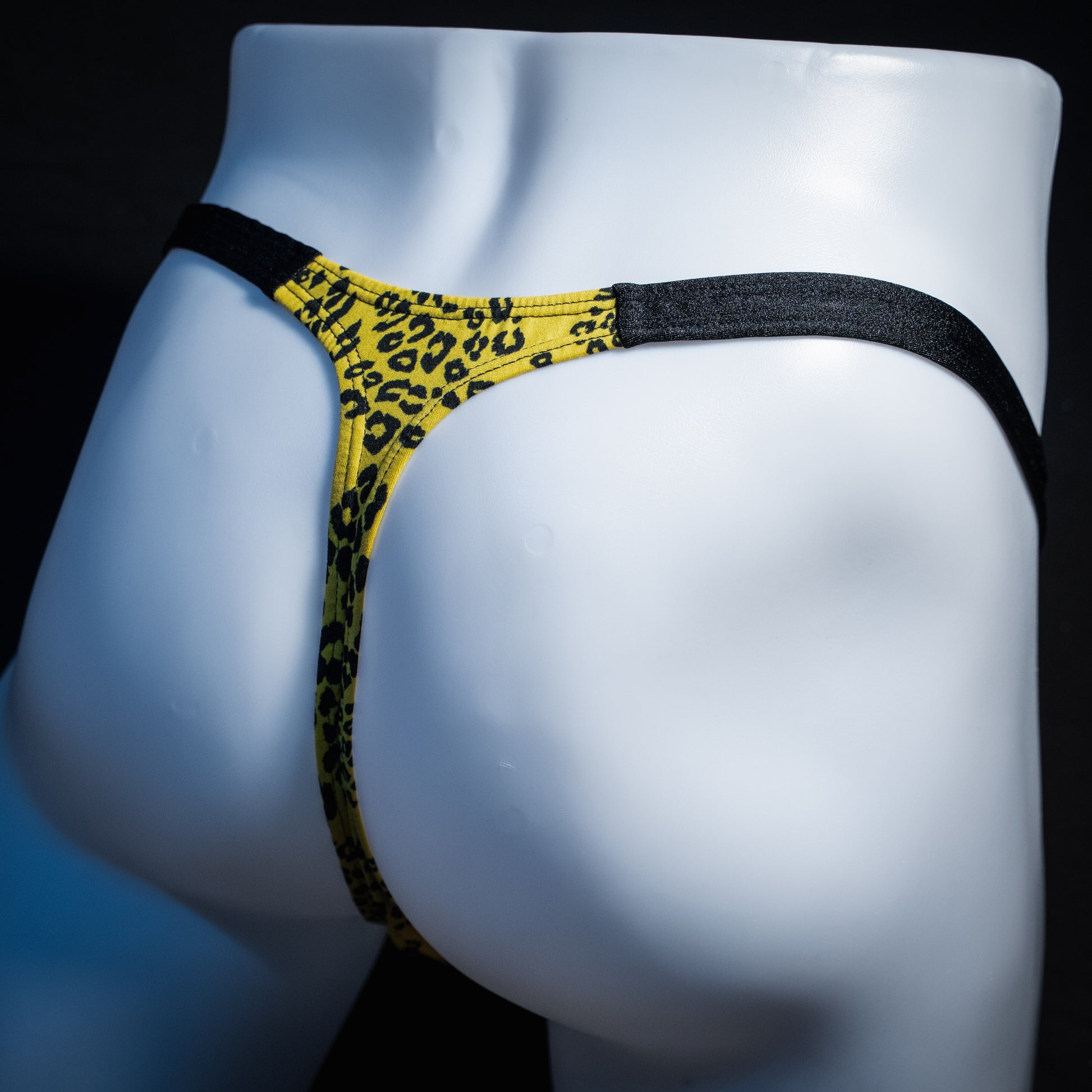 Men's yellow cheetah thong underwear, classic cut, rear view.