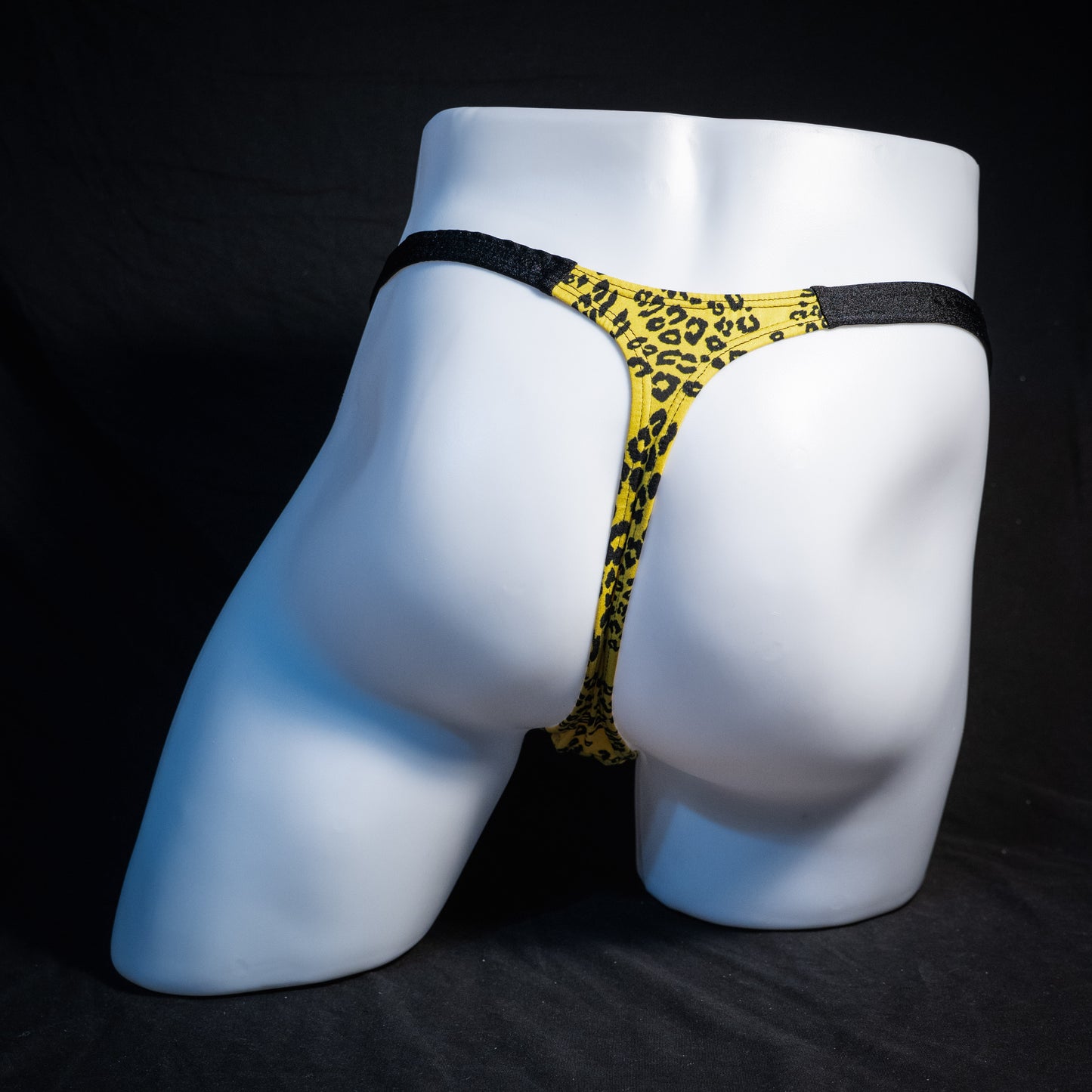 Men's yellow cheetah thong underwear, classic cut, rear view.