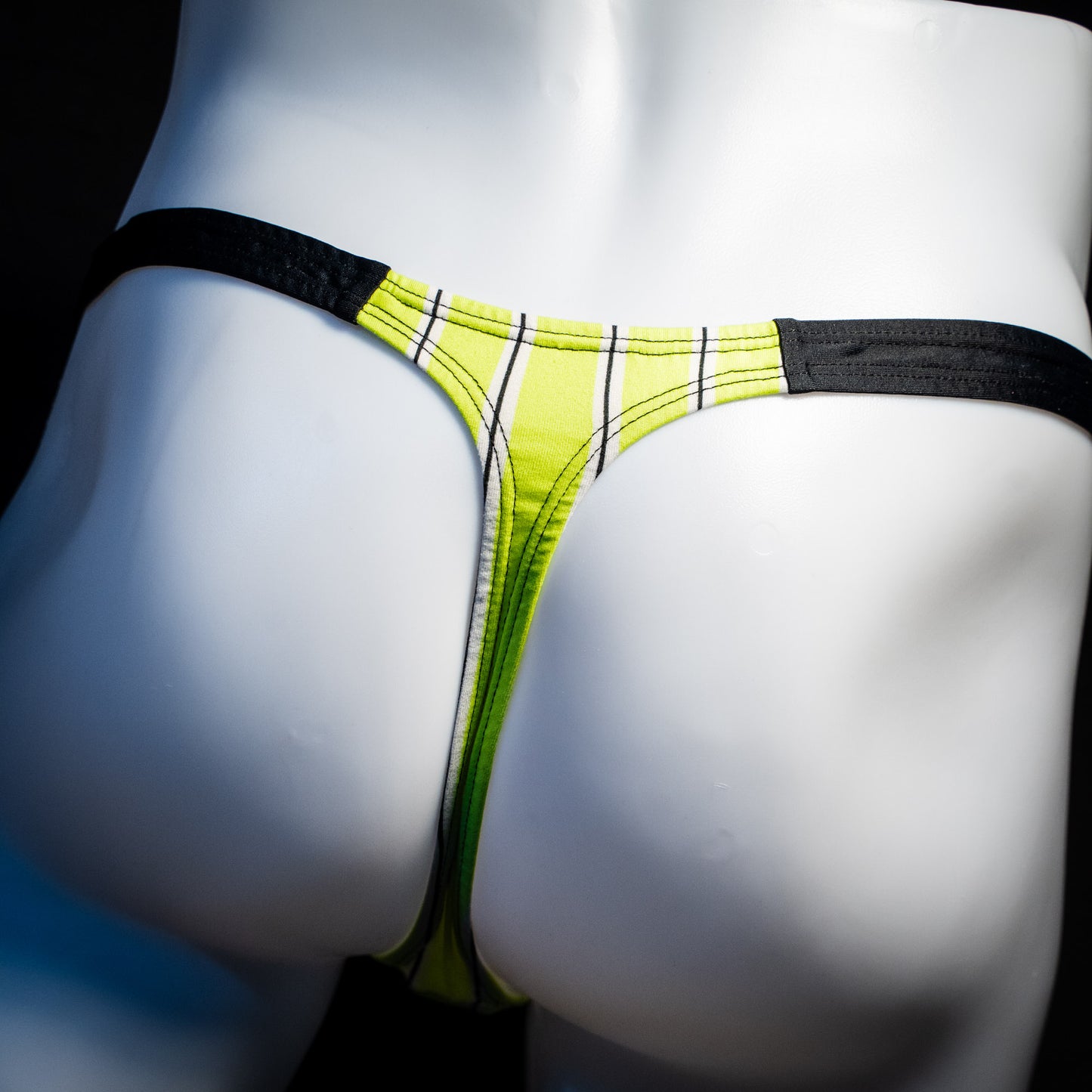 Men's yellow striped thong underwear, classic cut, rear view.