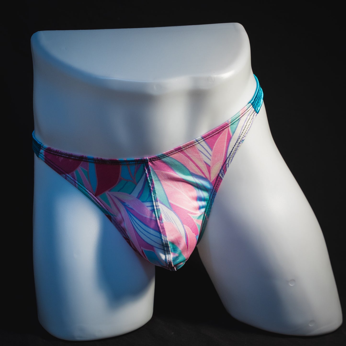 Men's pink and blue feathers thong underwear, classic cut, full front view.