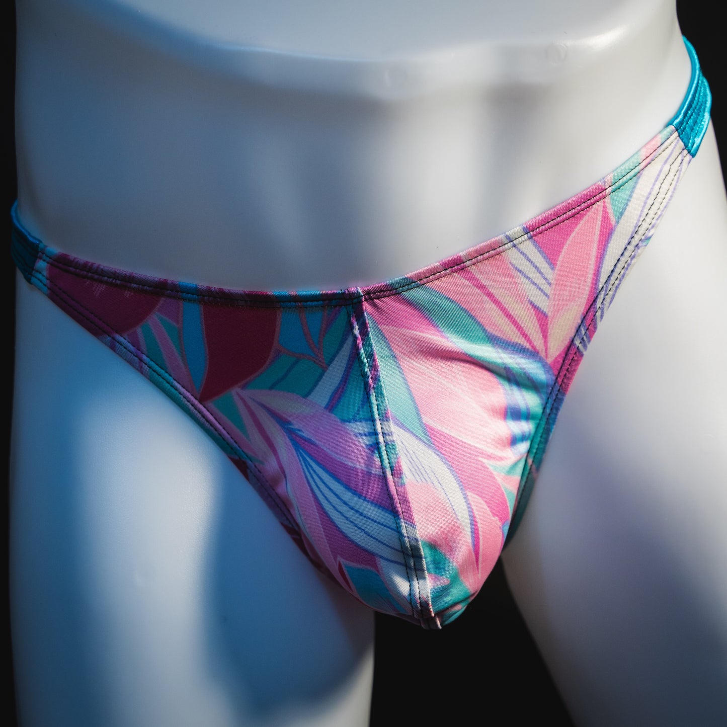 Men's pink and blue feathers thong underwear, classic cut, front view.
