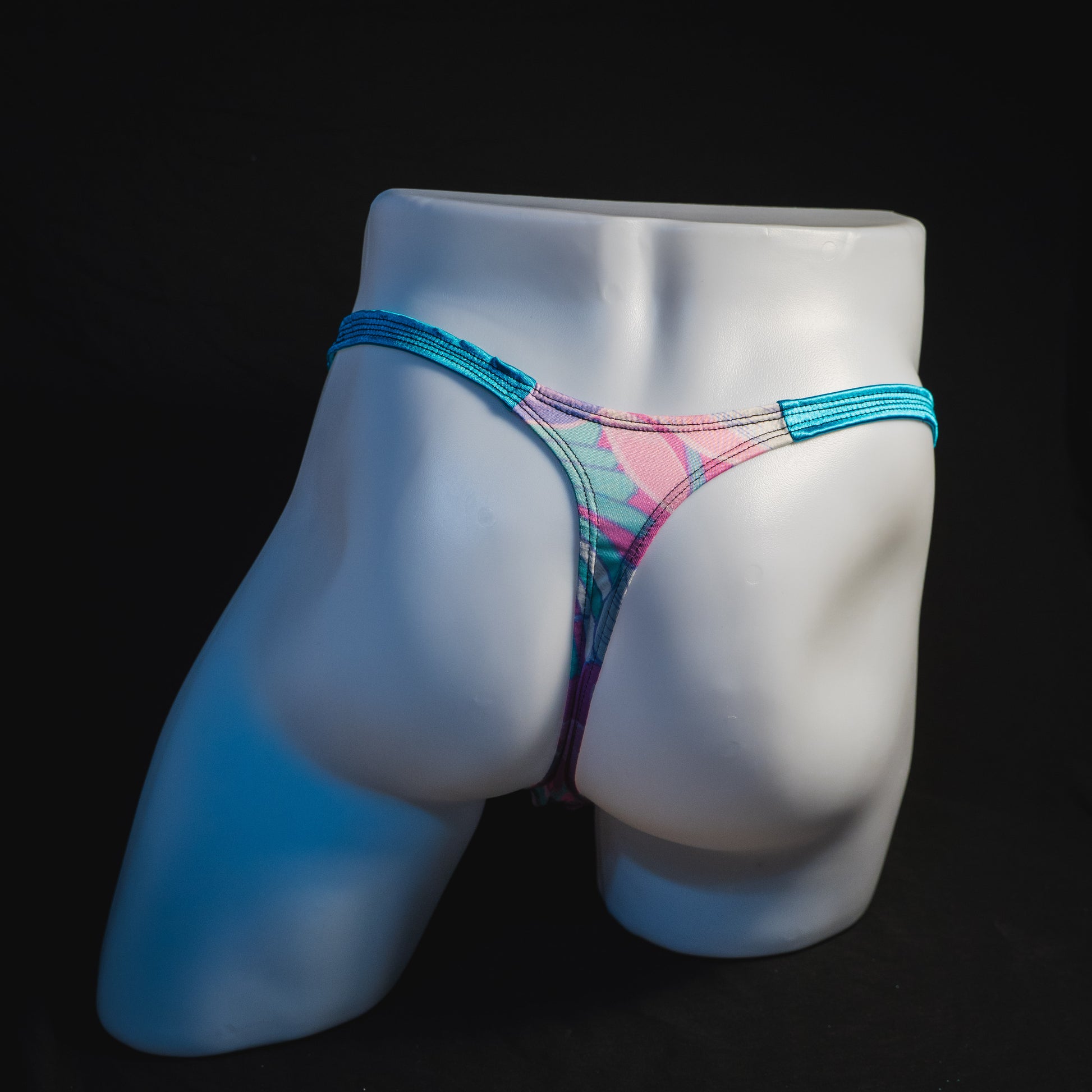 Men's pink and blue feathers thong underwear, classic cut, full rear view.