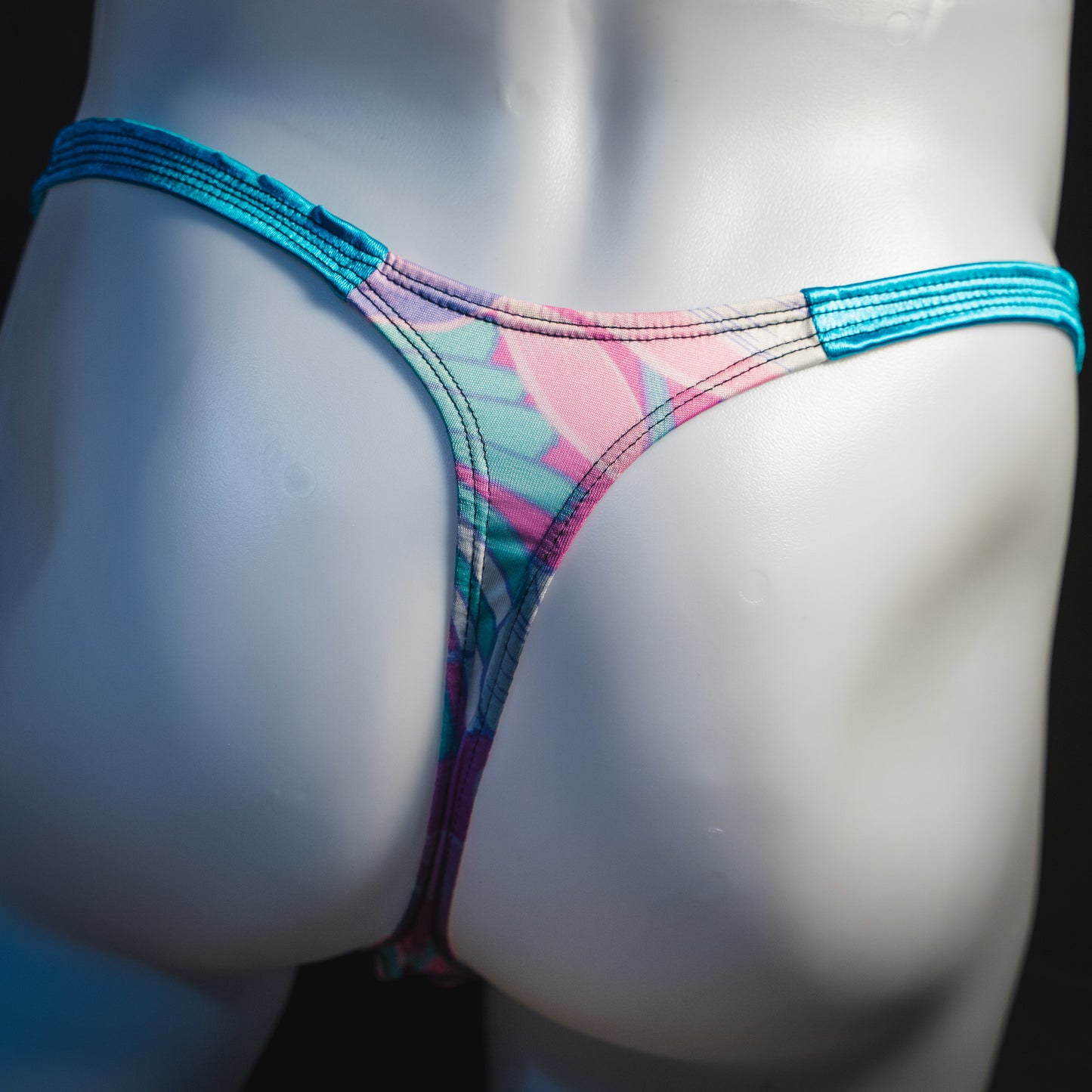 Men's pink and blue feathers thong underwear, classic cut, rear view.