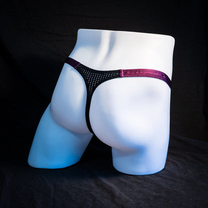 Men's mesh and plum purple thong underwear, classic cut, full angled rear view.