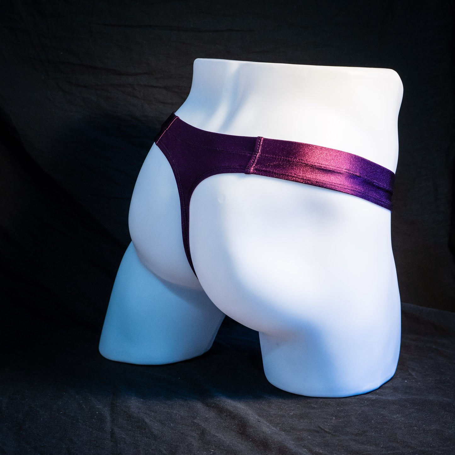 Men's plum purple robust cut thong underwear. full angled rear view.
