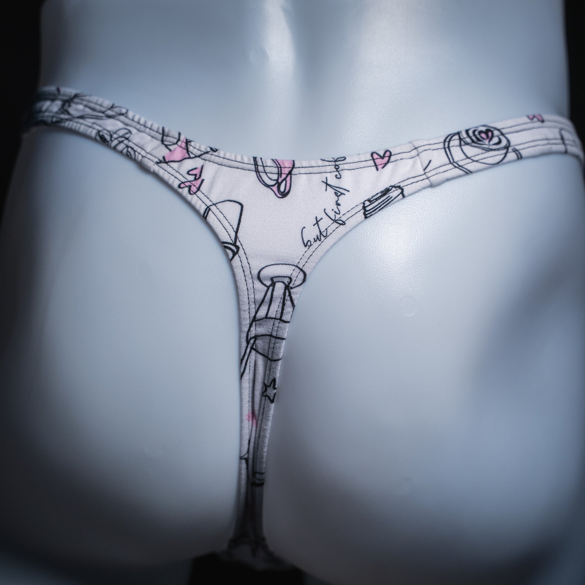 Men's thong with coffee mugs, classic cut, rear view.
