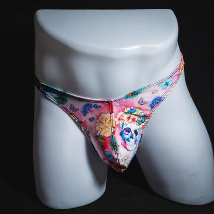 Men's pink skulls and floral thong underwear, classic cut, full front view.