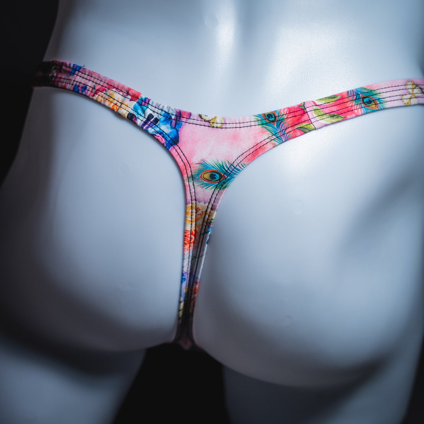 Men's pink skulls and floral thong underwear, classic cut, rear view.