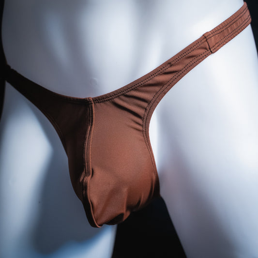 Men's solid brown thong, slim cut, angled front view.