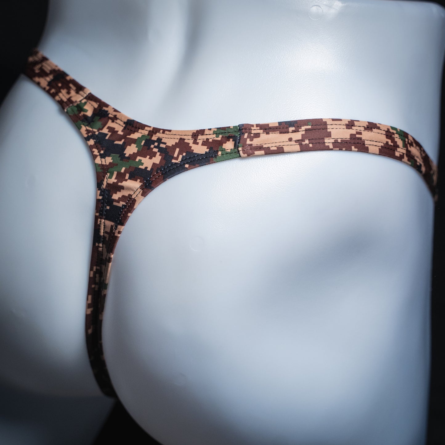 Men's digital camo thong, slim cut, angled rear view.