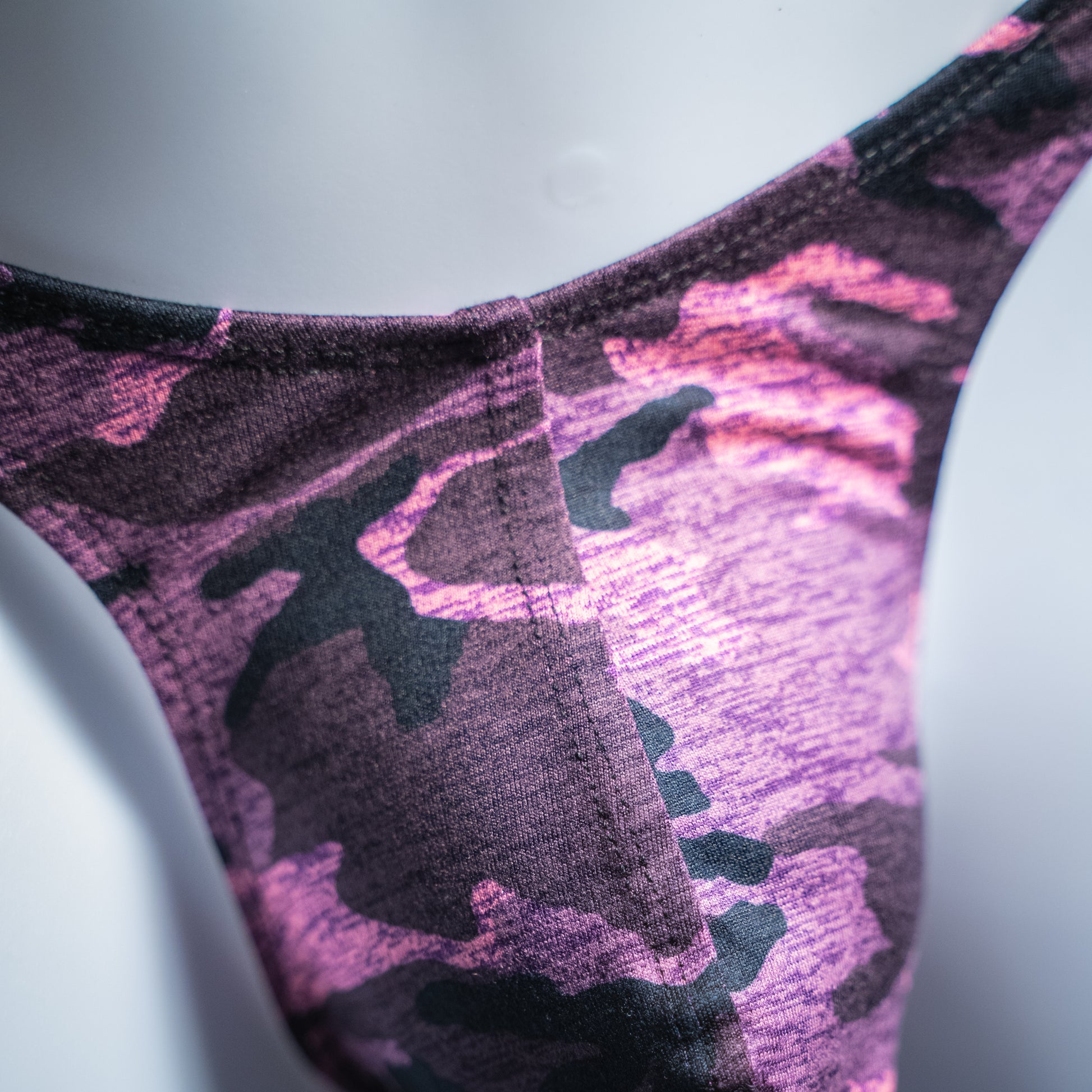 Men's pink camo thong, slim cut, closeup front view.