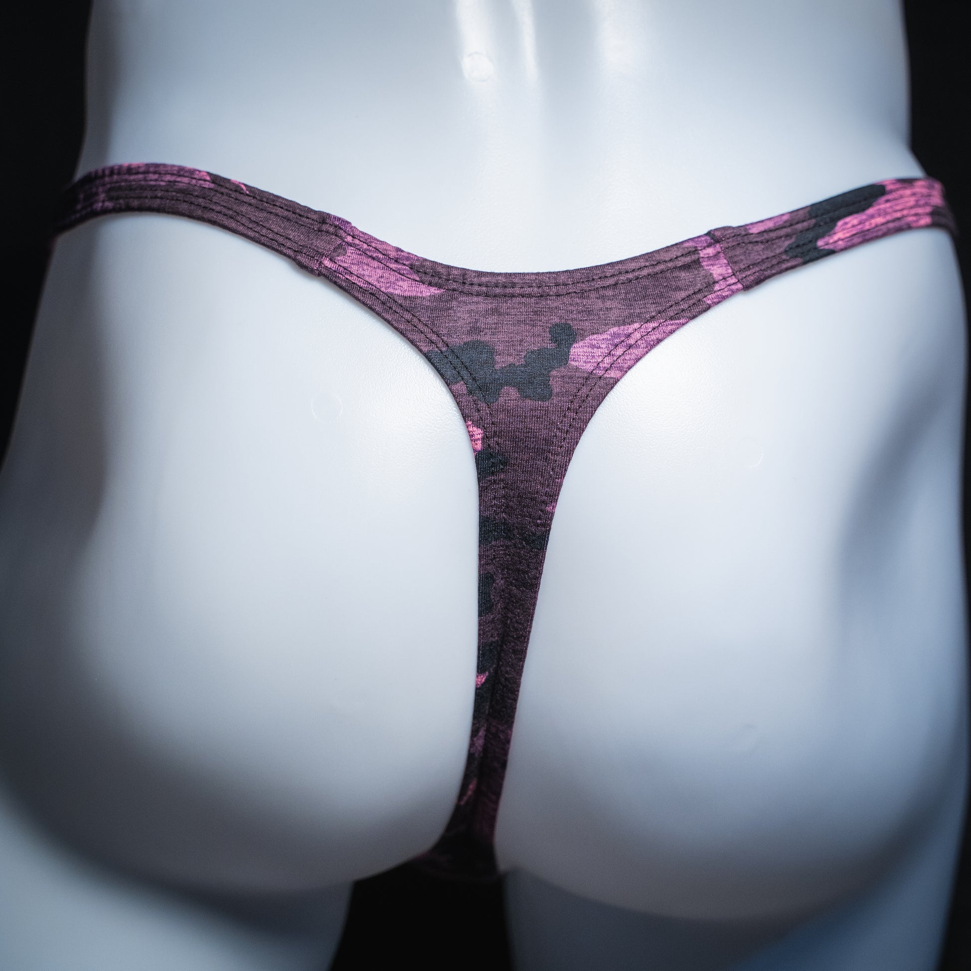 Men's pink camo thong, slim cut, rear view.