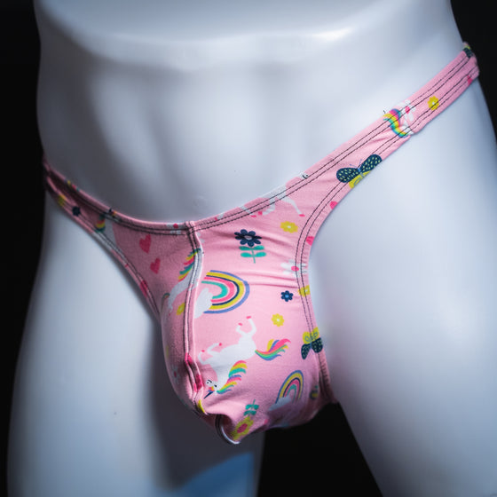 Men's pink unicorn thong, slim cut, angled front view.