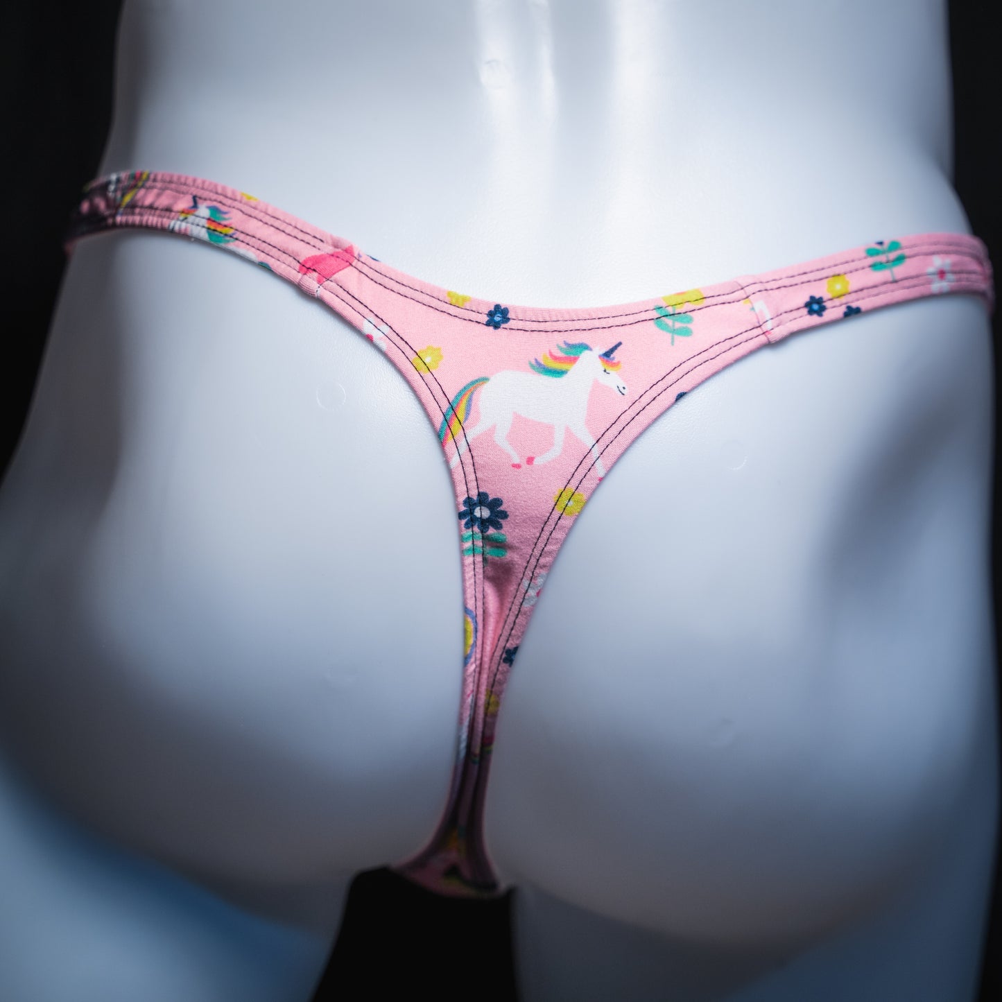 Men's pink unicorn thong, slim cut, rear view.