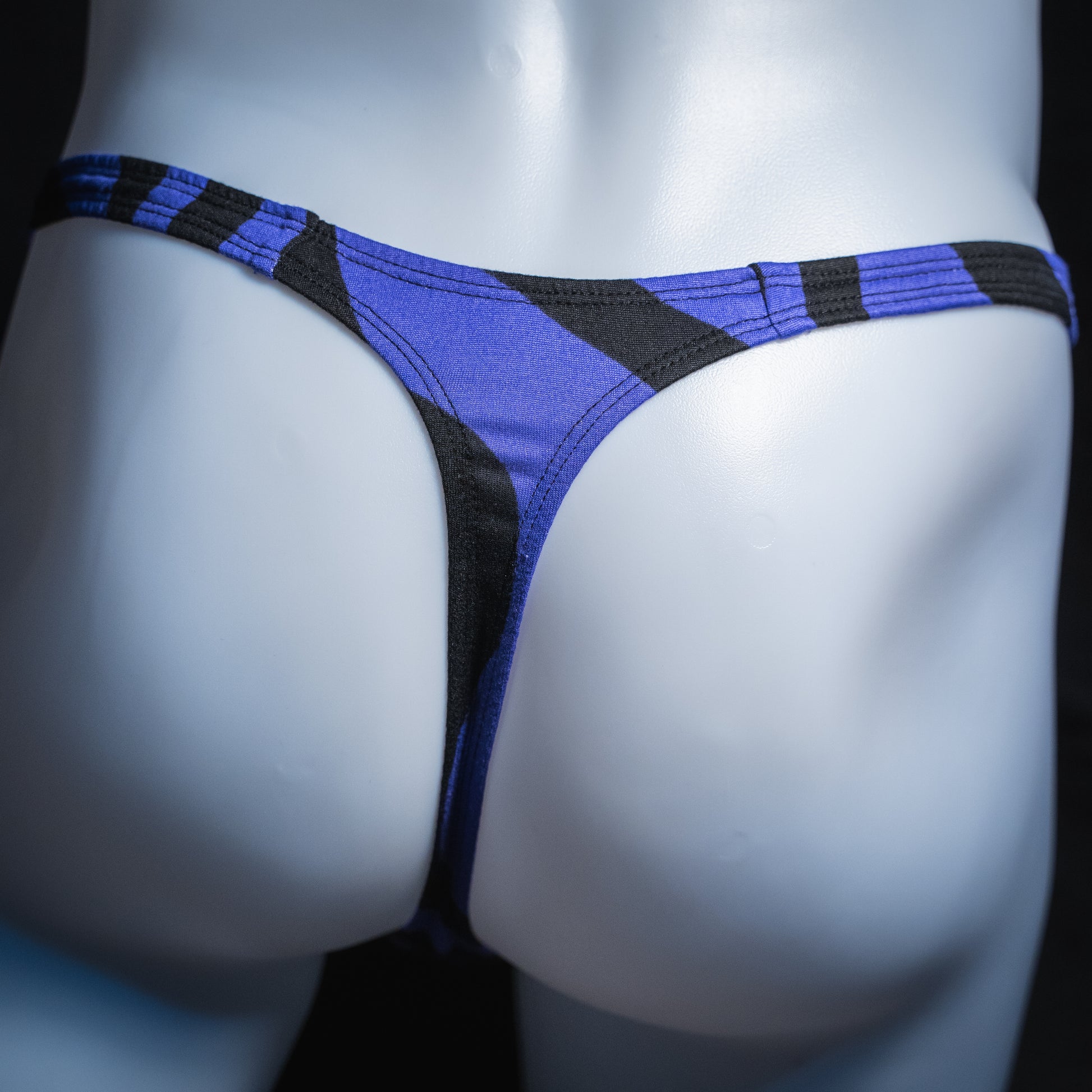 Men's purple and black thong, slim cut, rear view./