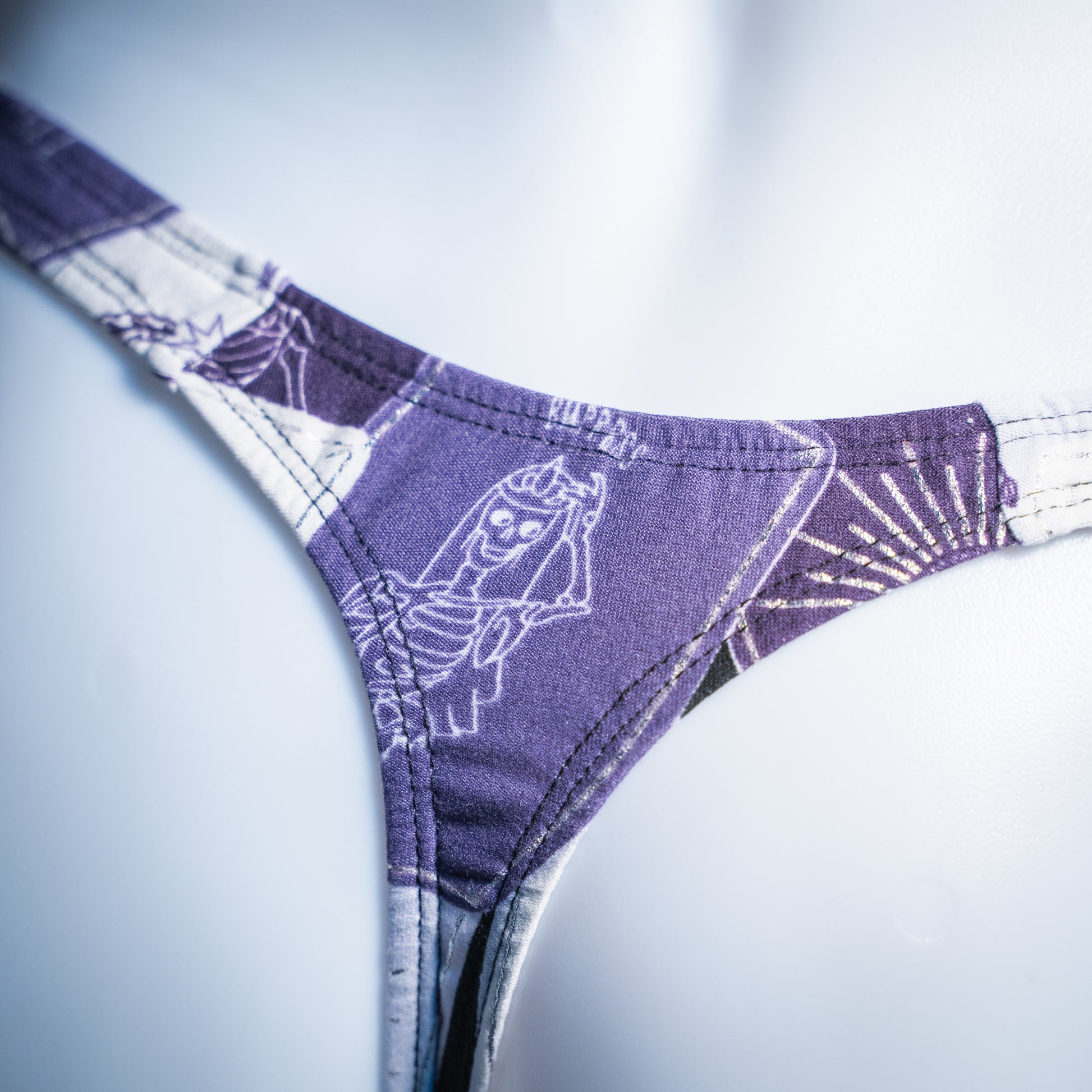 Men's purple tarot card thong, slim cut, closeup rear view.