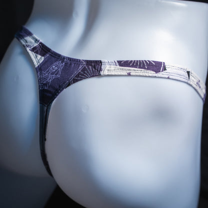 Men's purple tarot card thong, slim cut, angled rear view.