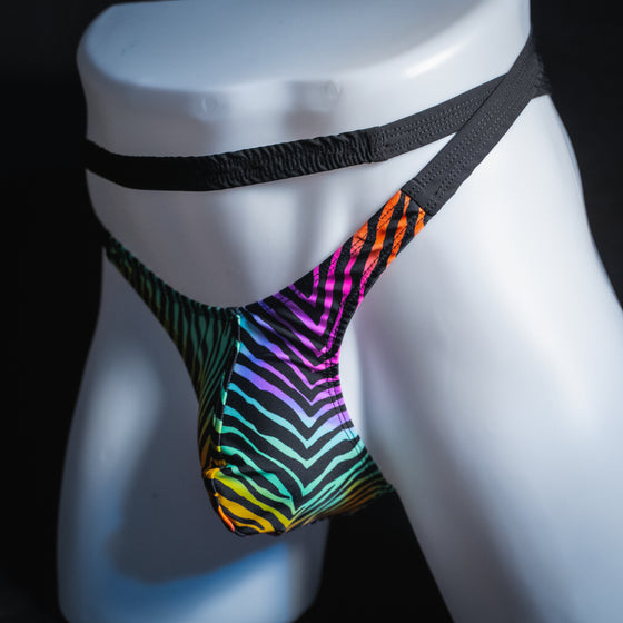 Men's rainbow zebra double strap thong, slim cut, angled front view.