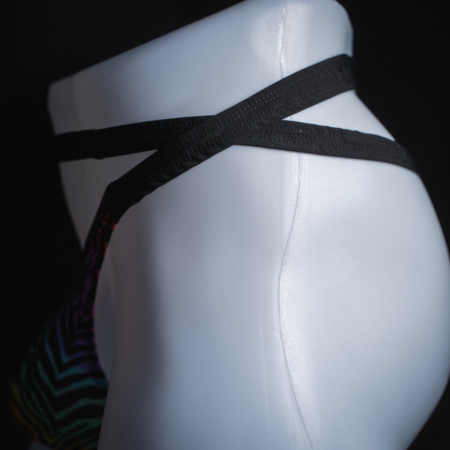 Men's rainbow zebra double strap thong, slim cut, side view.