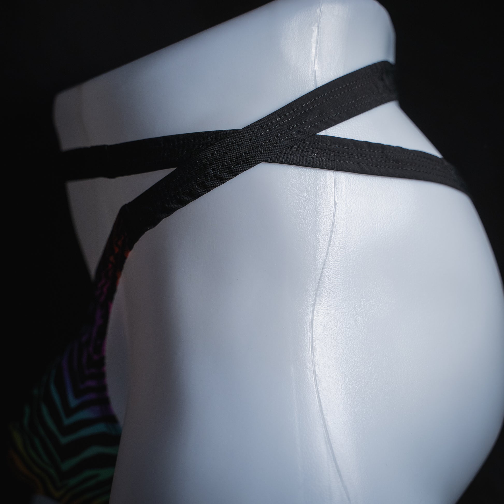 Men's rainbow zebra double strap thong, slim cut, side view.