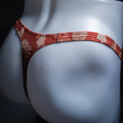 Men's red Christmas themed thong, slim cut, angled rear view.