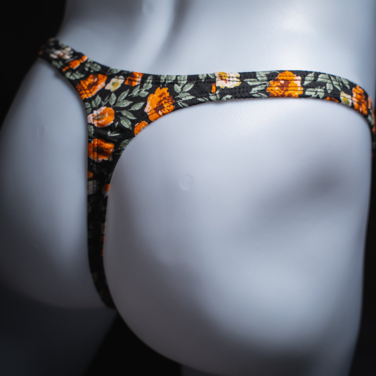 handmade mens thong underwear, classy floral design, soft polyester material, classic cut variation, angled back view