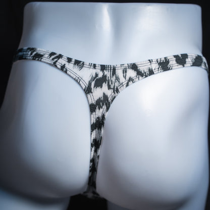 Men's black and white abstract cheetah thong, classic cut, rear view.