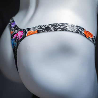 Men's sketch floral thong, slim cut, angled rear view.