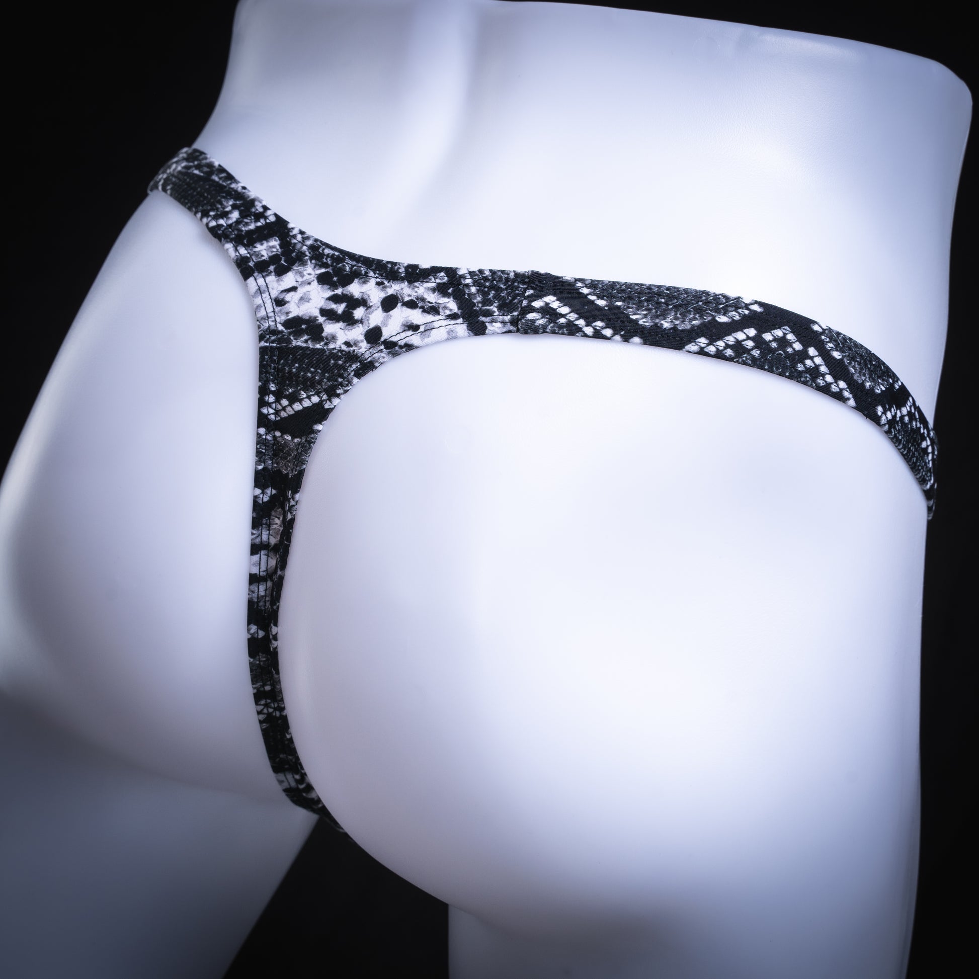 handmade mens thong underwear, black and white snakeskin print, spandex material, slim cut, angled back view