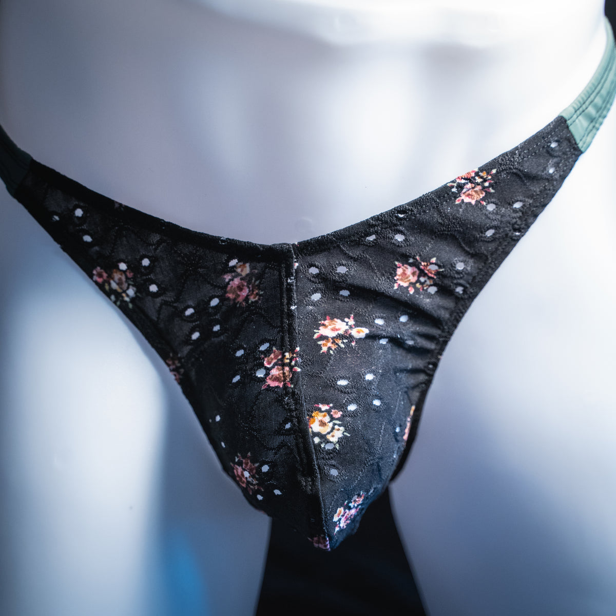 handmade mens thong underwear, black floral eyelet pattern, soft polyester material, classic cut variation, front view