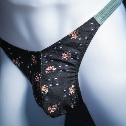 handmade mens thong underwear, black floral eyelet pattern, soft polyester material, classic cut variation, angled front view