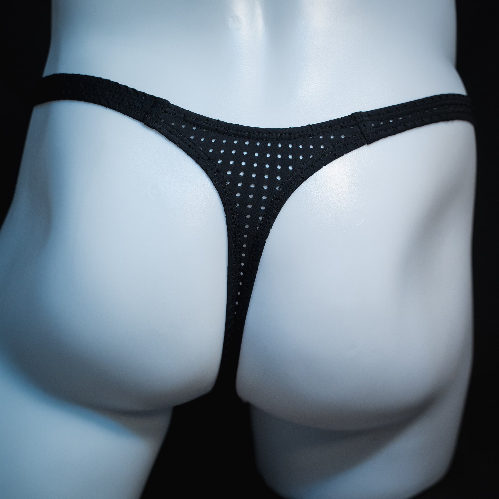 men's black mesh thong underwear, slim cut, rear view.