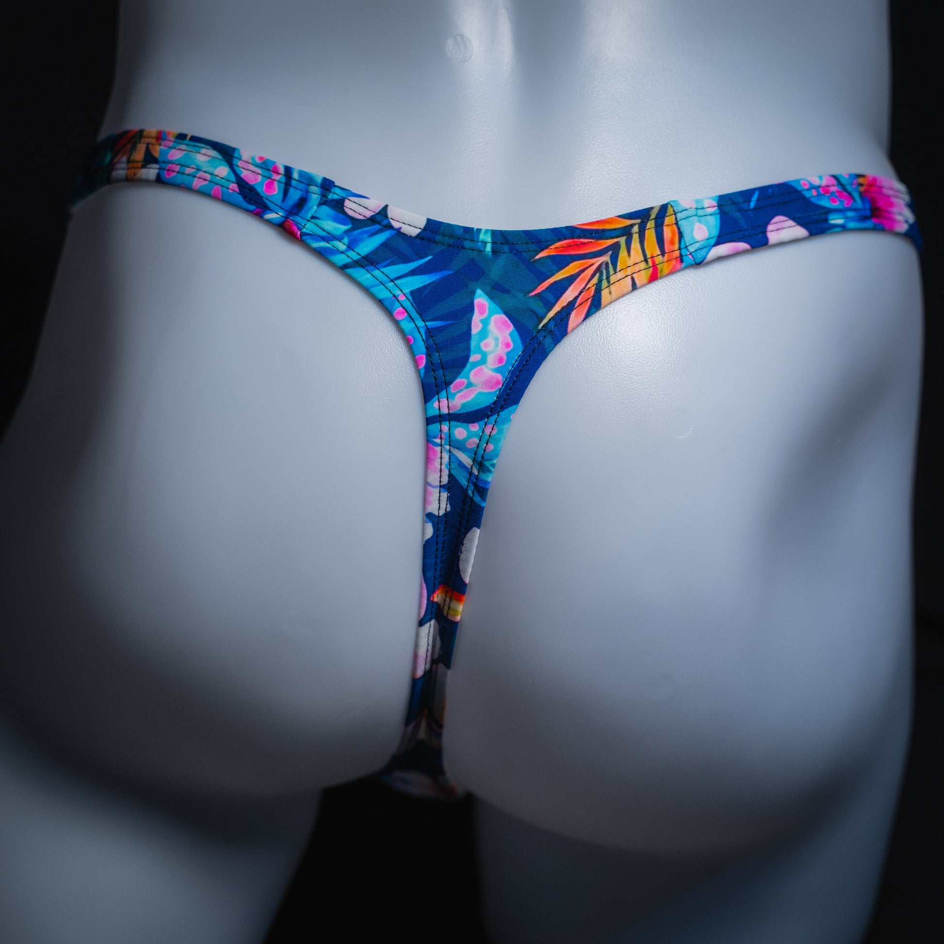 Mens' blue floral thong, slim cut, rear view.