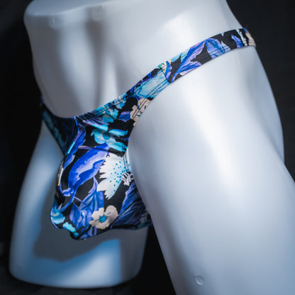 Men's blue floral thong, slim cut, angled front view.