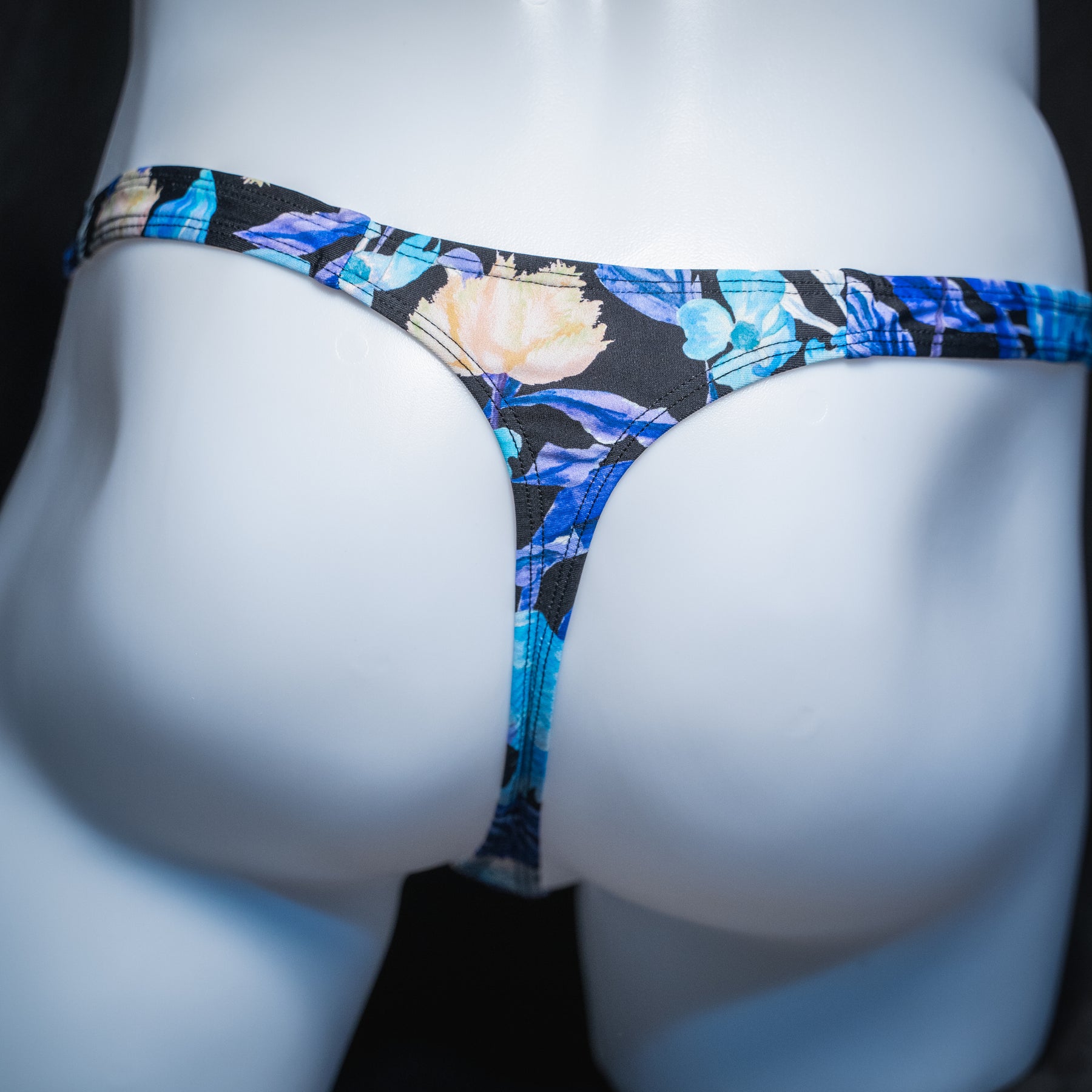 Men's blue floral thong, slim cut, rear view.