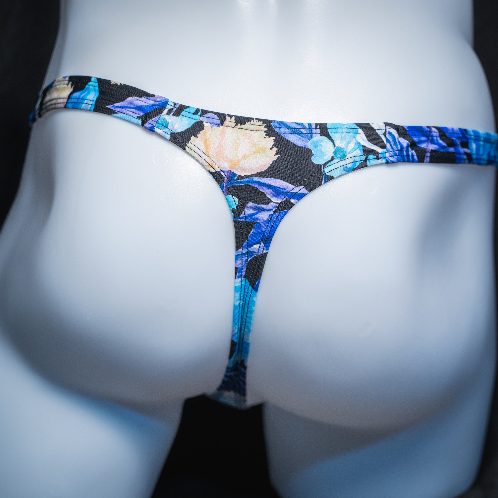 Men's blue floral thong, slim cut, rear view.