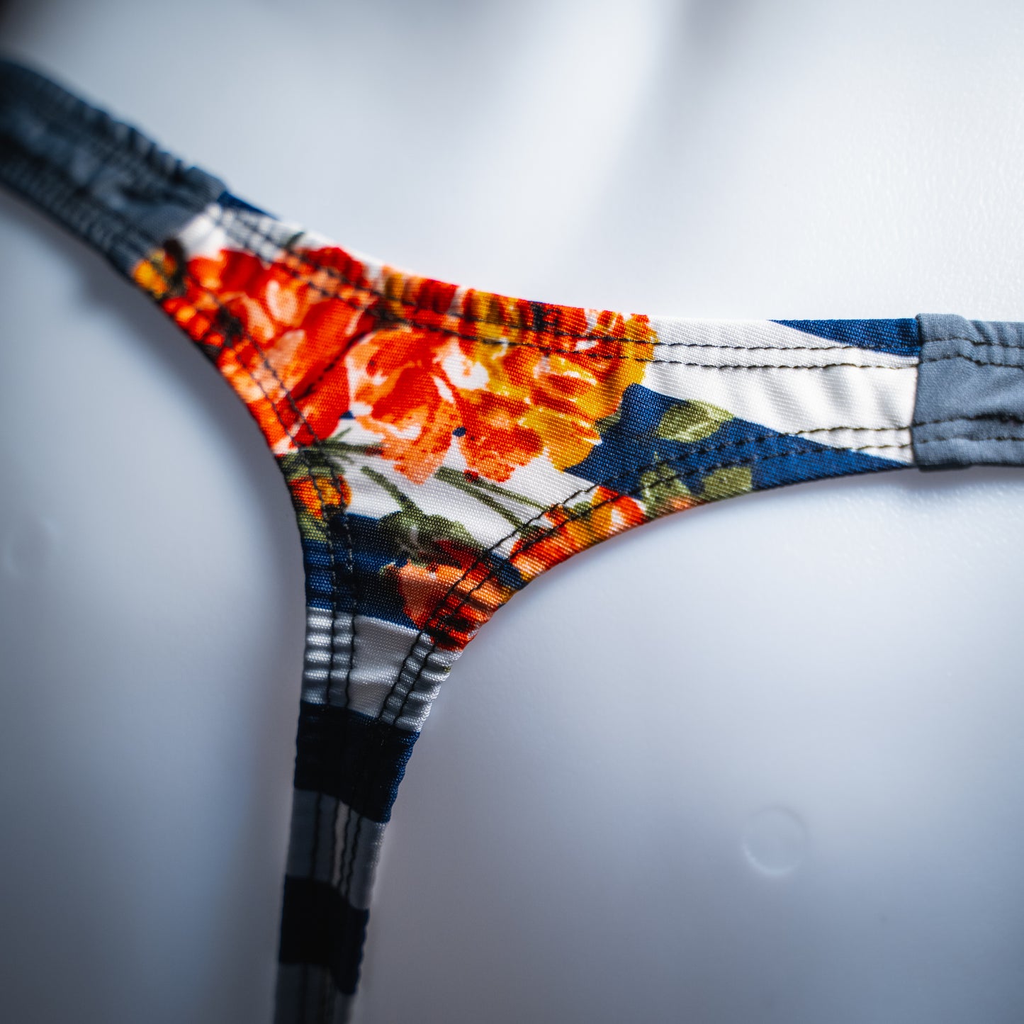 handmade mens thong underwear, floral striped pattern, polyester material, classic cut variation, closeup angled back view