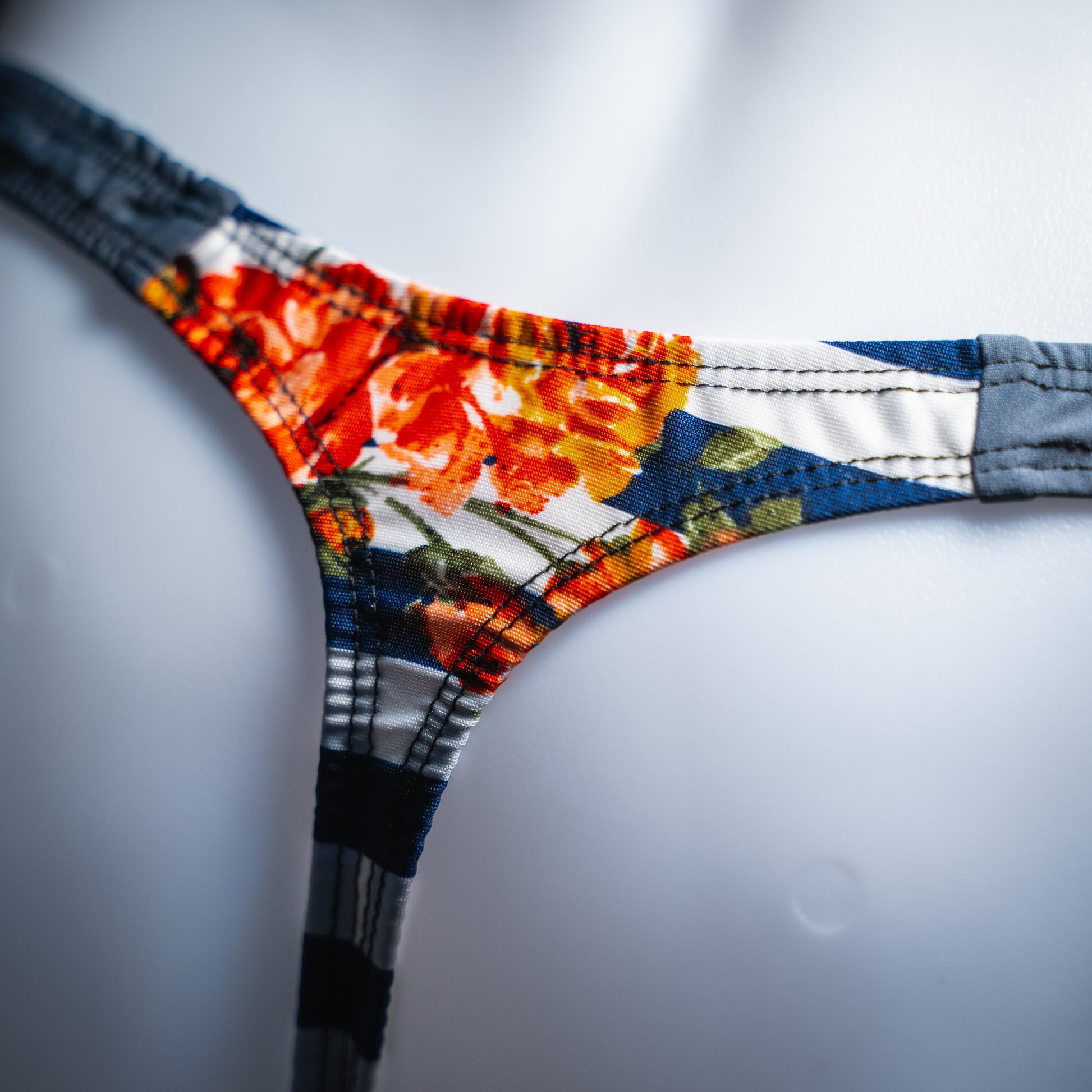 handmade mens thong underwear, floral striped pattern, polyester material, classic cut variation, closeup angled back view