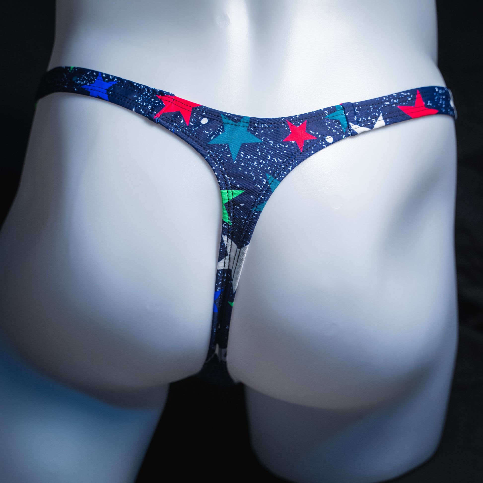Men's stars on blue thong, slim cut, rear view.