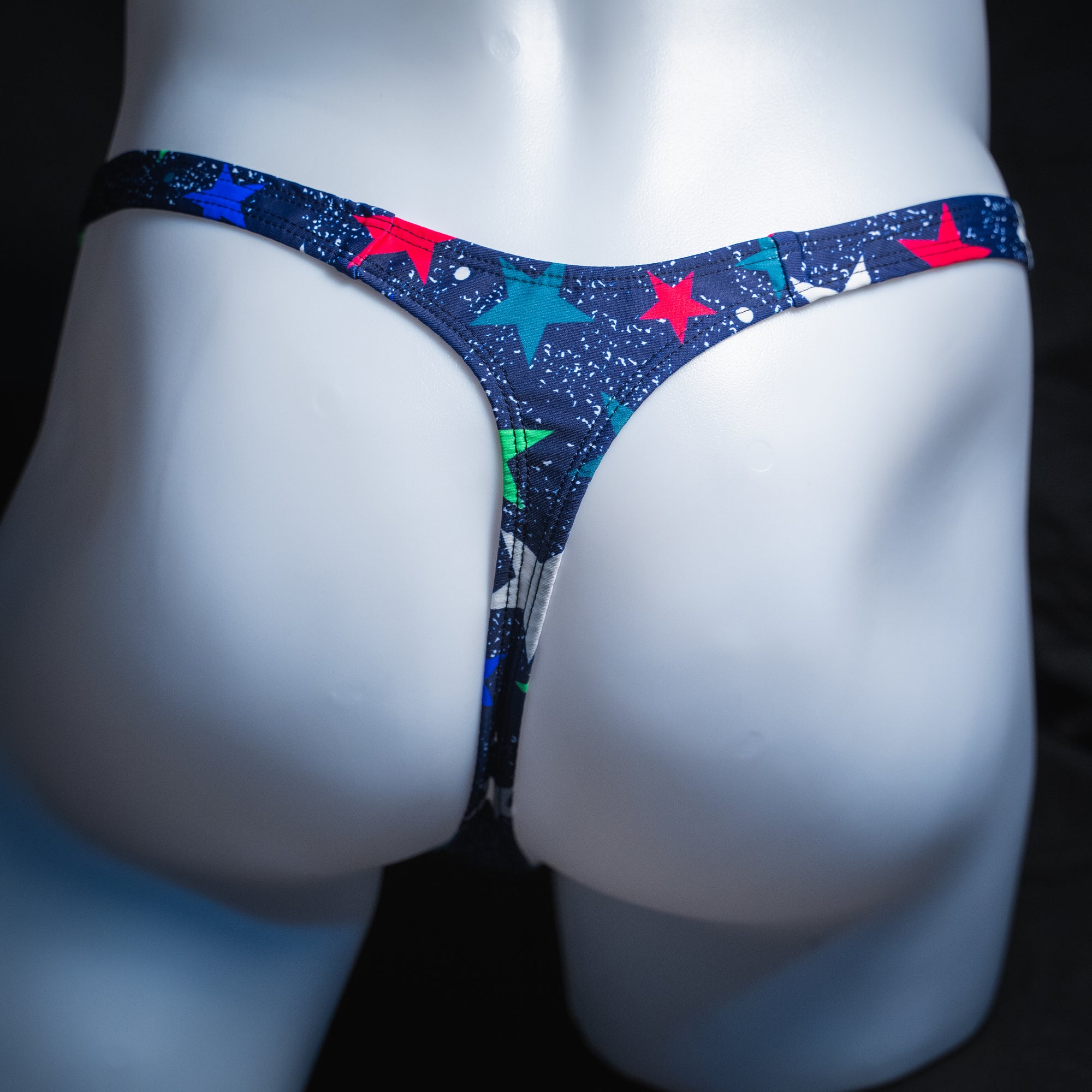 Men's stars on blue thong, slim cut, rear view.