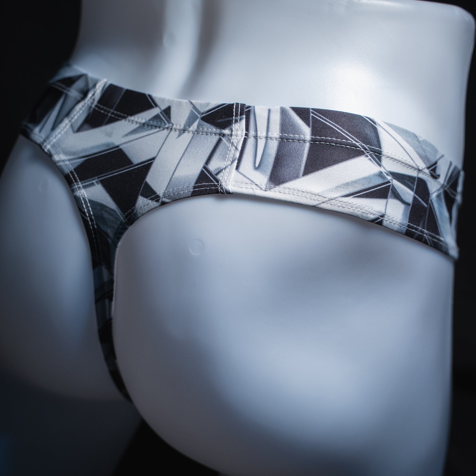 handmade mens thong underwear, black and white geometrical shapes print, brief cut design, angled back view