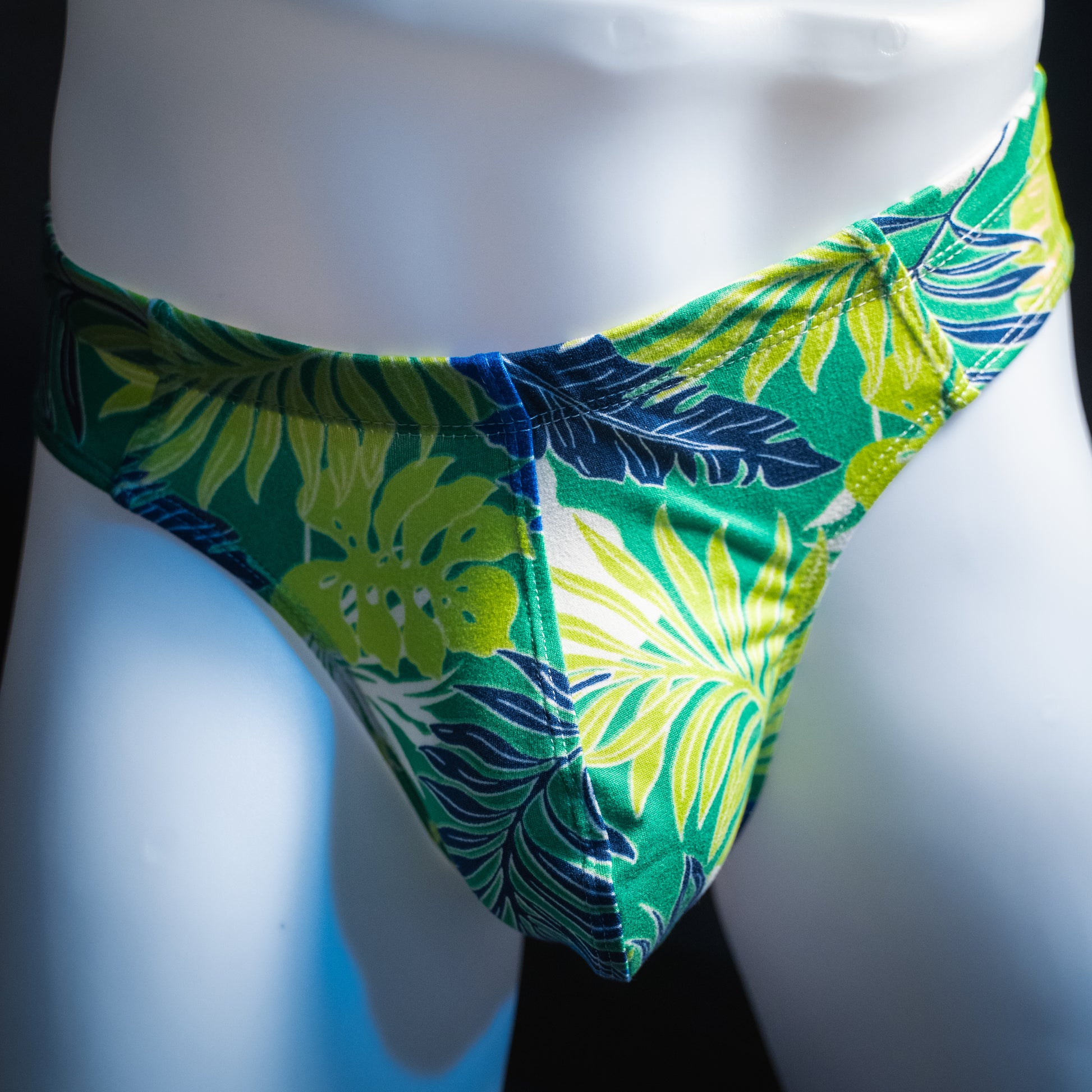 handmade mens thong underwear, green tropical leaves print, soft polyester material, brief cut design, front view