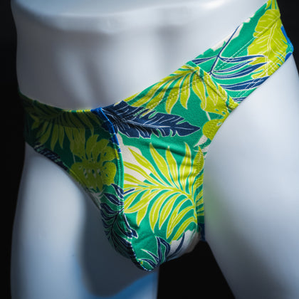 handmade mens thong underwear, green tropical leaves print, soft polyester material, brief cut design, angled front view
