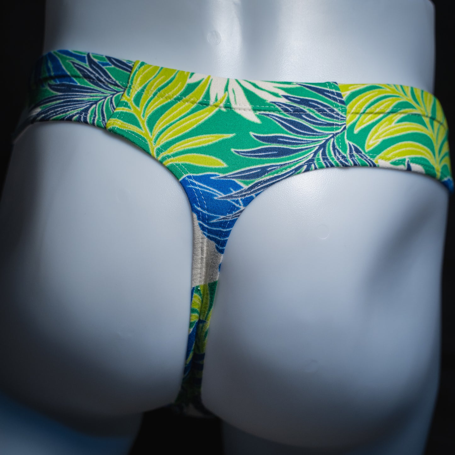 handmade mens thong underwear, green tropical leaves print, soft polyester material, brief cut design, back view