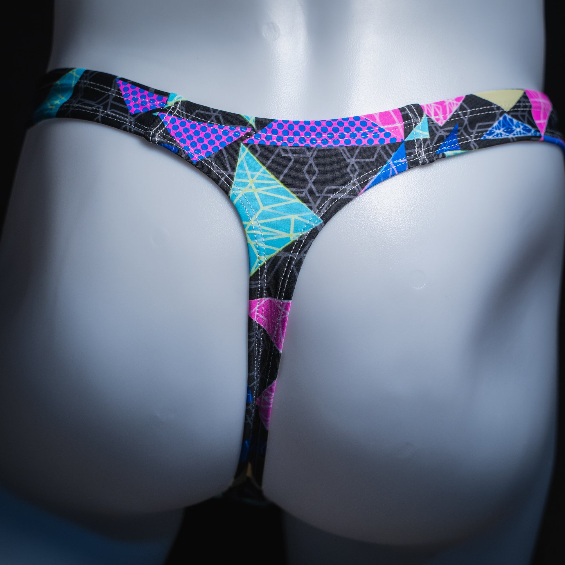 handmade mens thong underwear, bright geometric shapes pattern, robust cut design, spandex material, back view