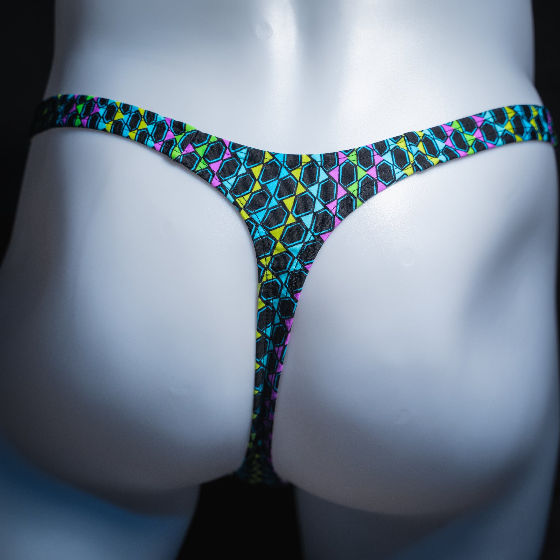 Men's colorful wavy line thong, slim cut, rear view.