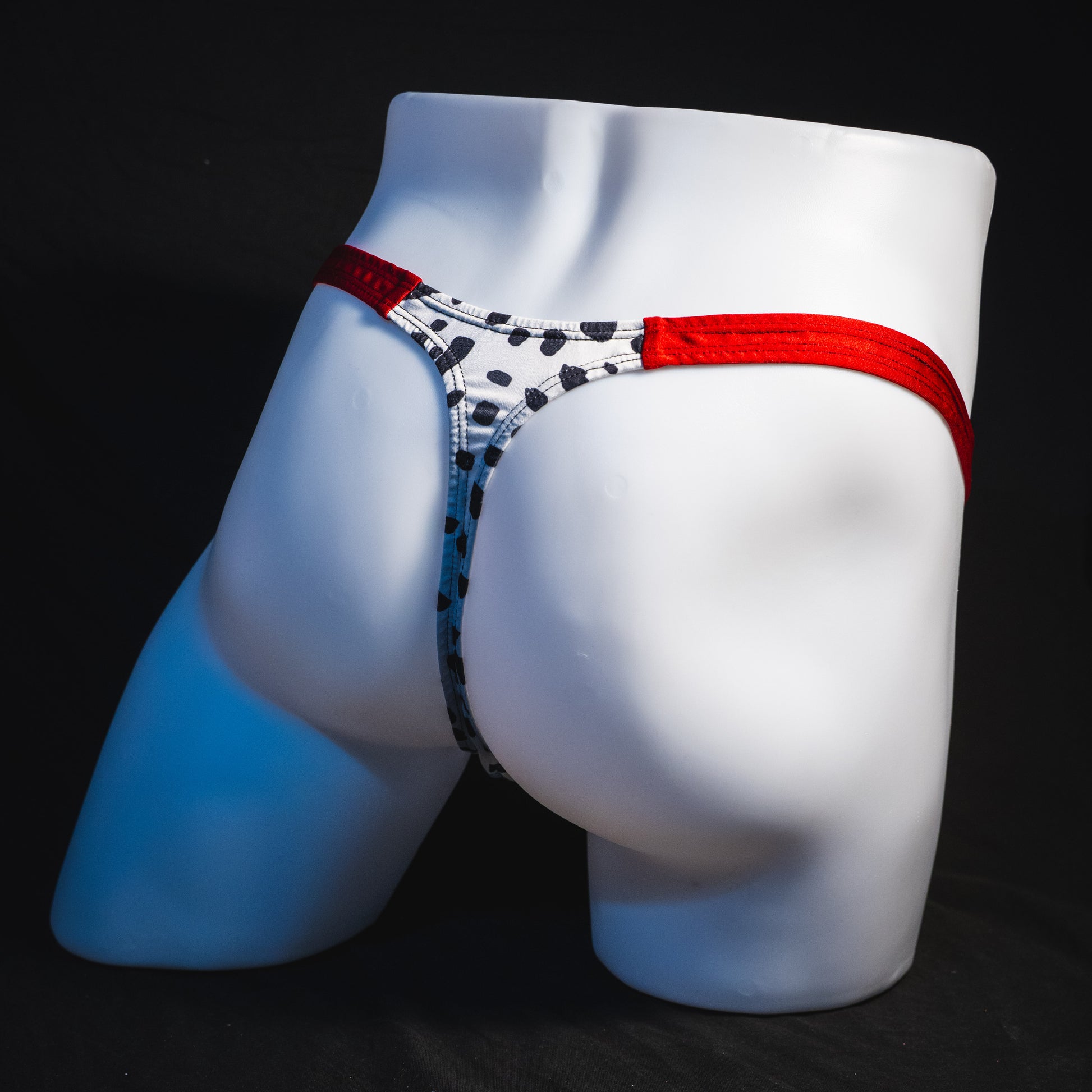Men's dalmatian thong underwear, classic cut, full angled rear view.